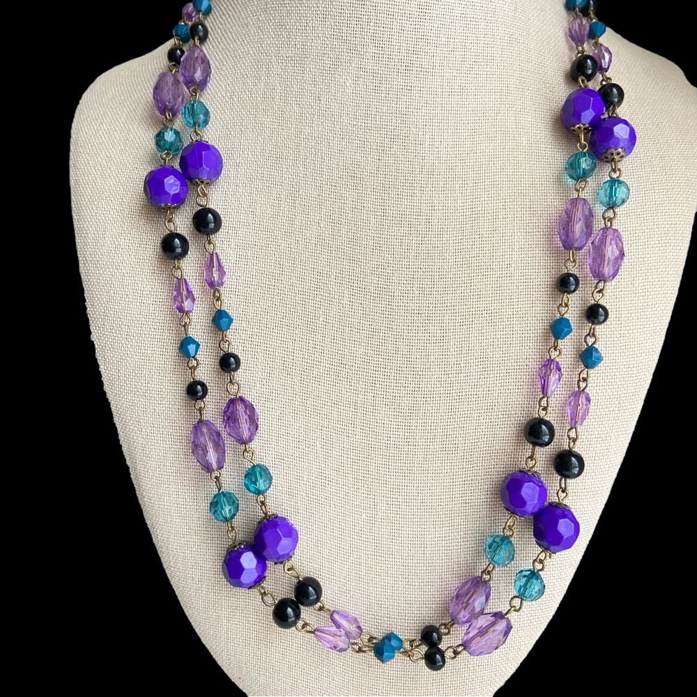 Purple teal and black faceted acrylic beads on a continuous strand necklace